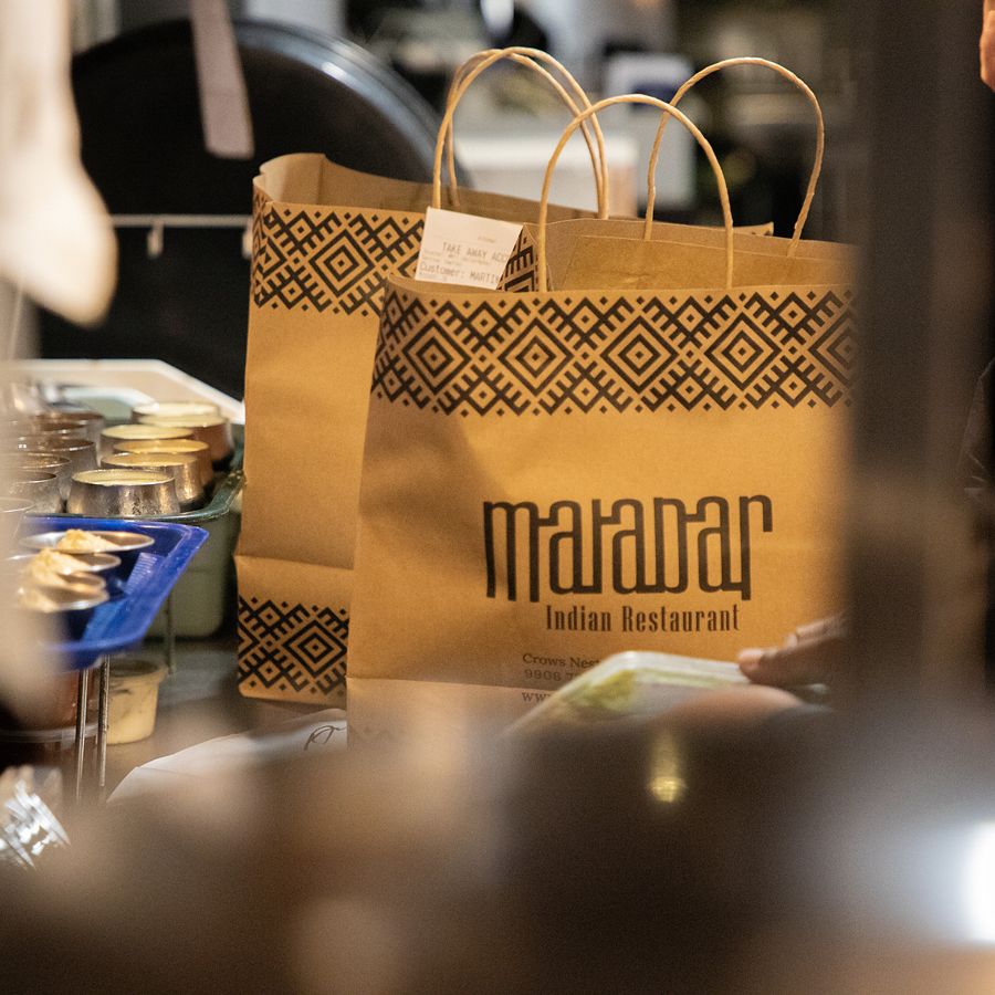 Malabar takeaway bags at the pass, ready to collect