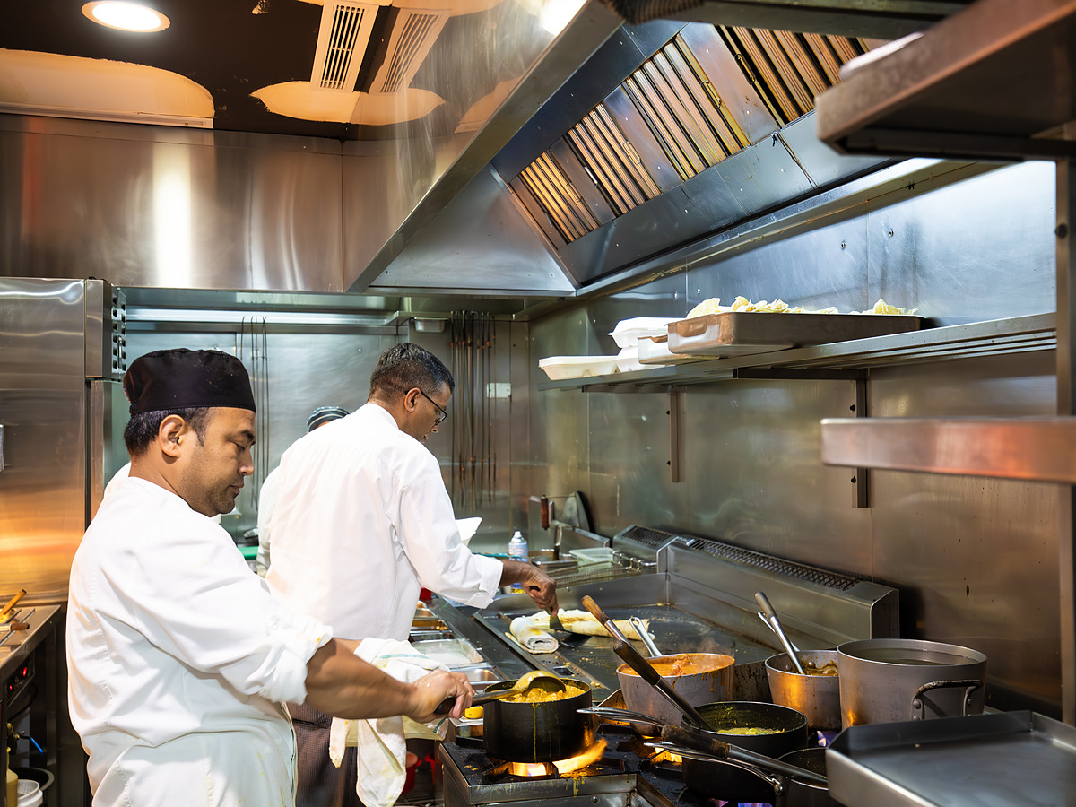 The Malabar kitchen during service, pots over the flame